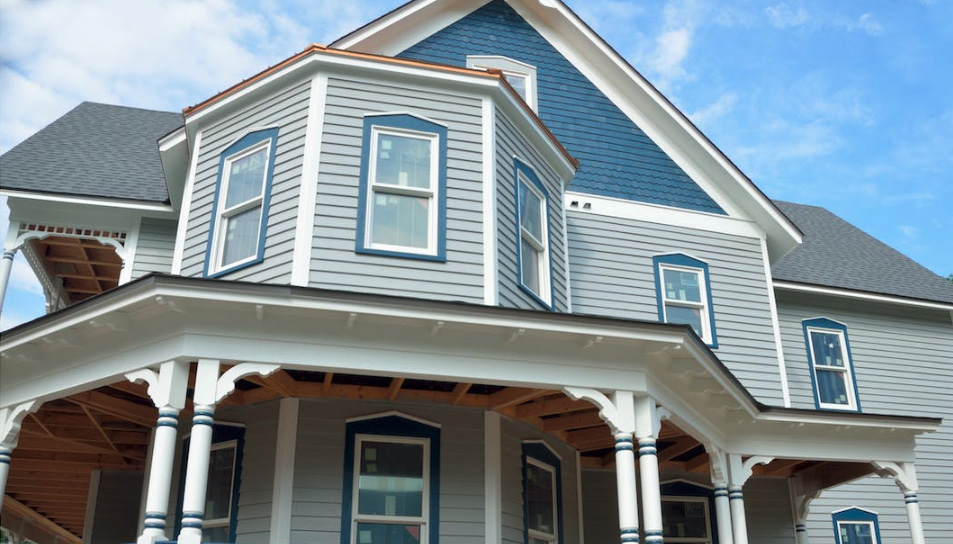 house with light blue siding and blue window casings