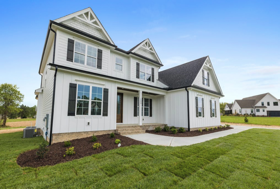 house with white siding and grass lawn copy